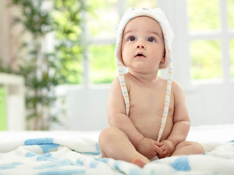 learning_to_sit_infant_with_hat_babyinfo_a_1556959285